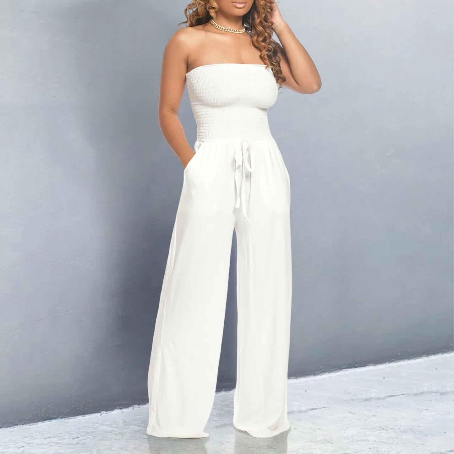 Strapless jumpsuit with ruched detail and lace-up design. Wide-leg, stylish, and perfect for a bold look.