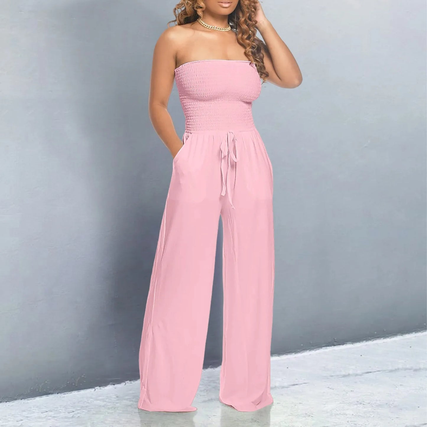 Strapless jumpsuit with ruched detail and lace-up design. Wide-leg, stylish, and perfect for a bold look.