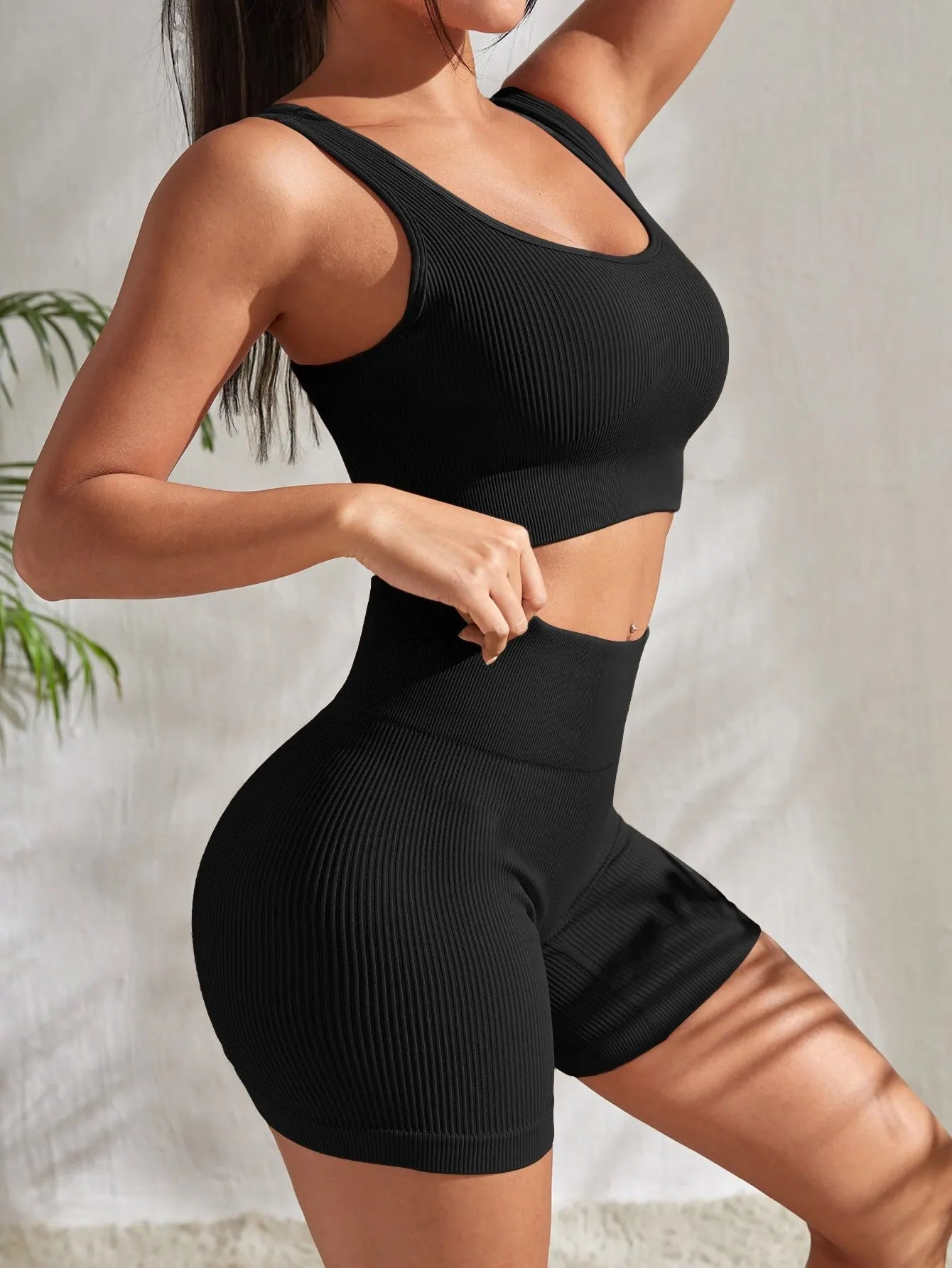 2-piece women's workout set – ribbed crop top and high-waist shorts.