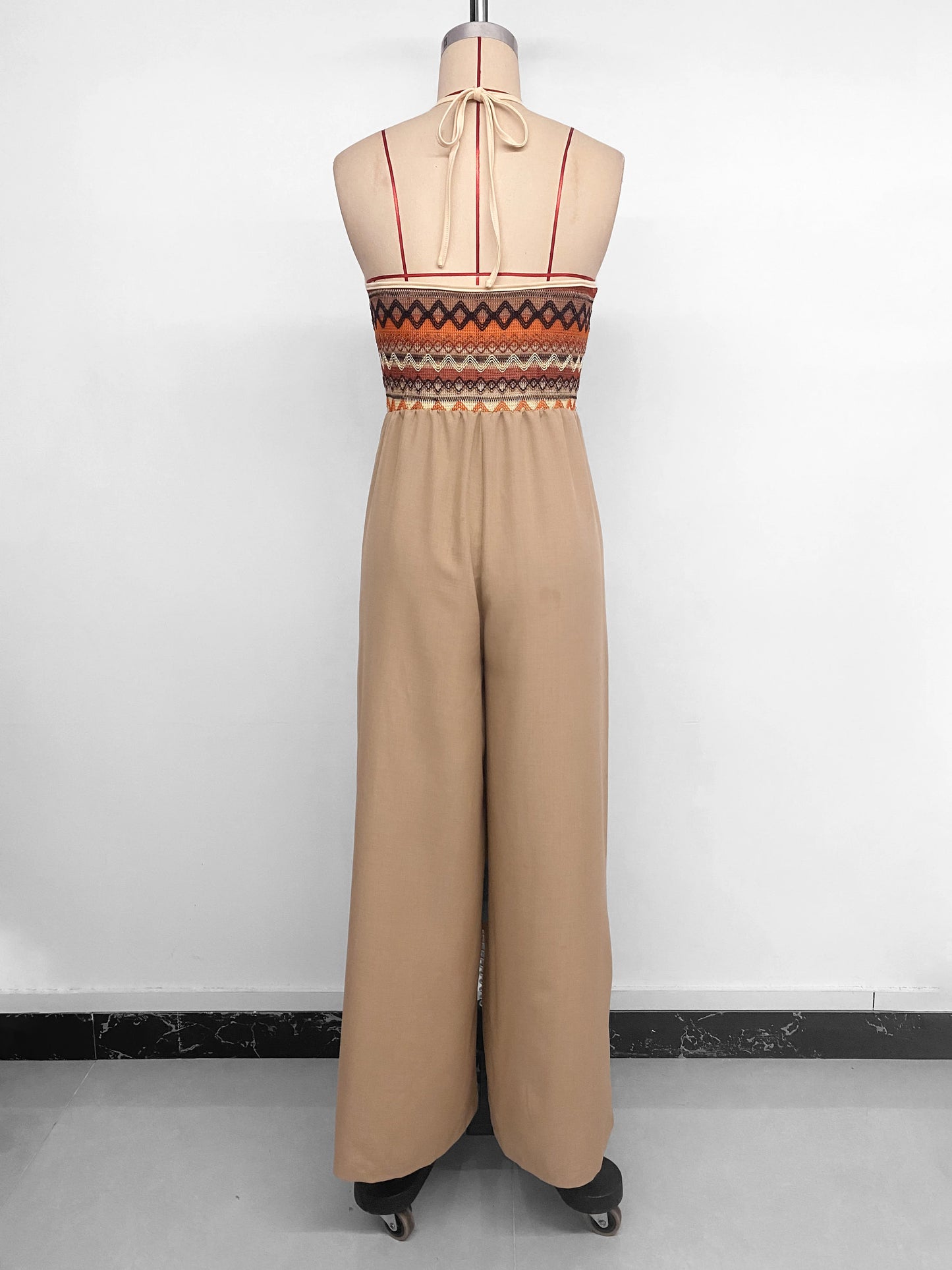 Retro beachwear jumpsuit with ethnic embroidery and collar detail. Lightweight, stylish, and perfect for