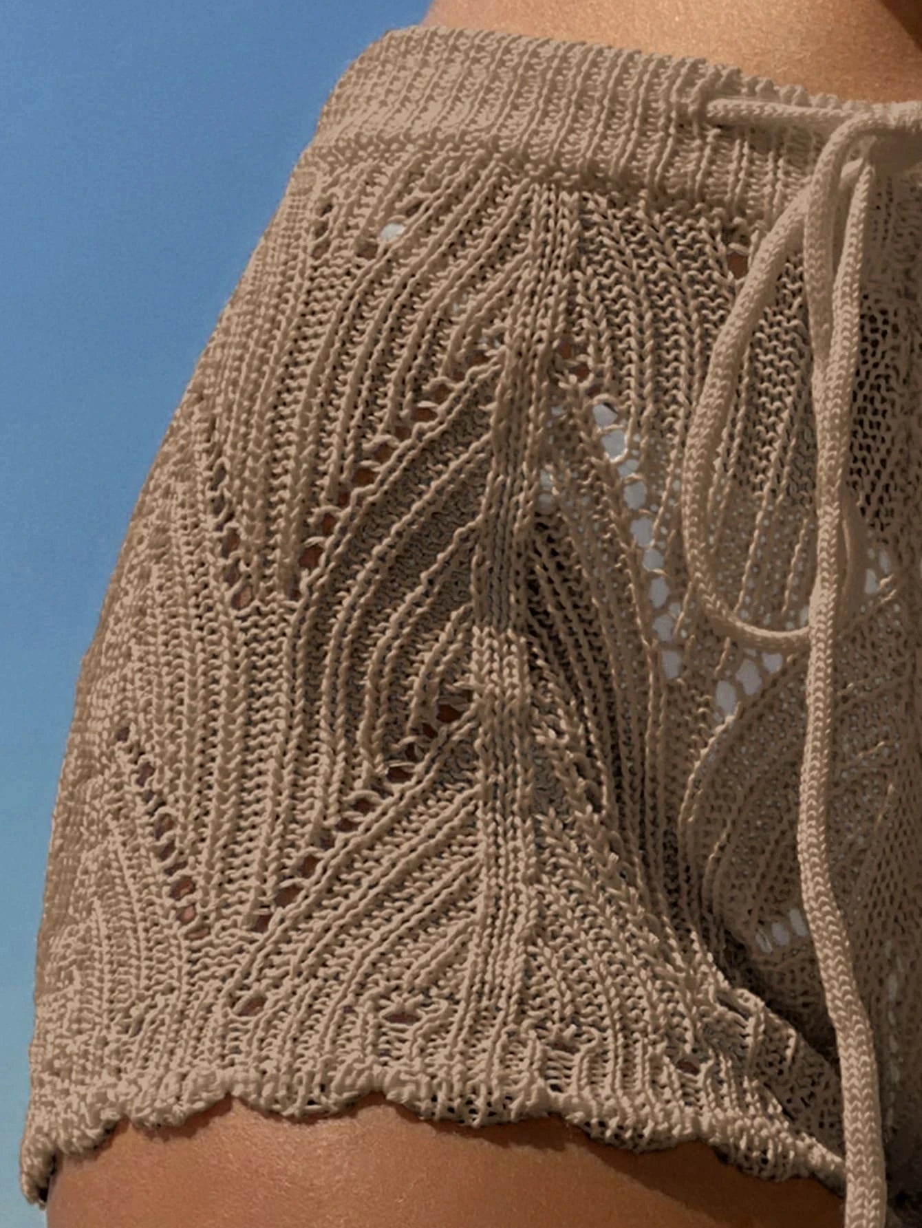 Knit shorts with hollow details and adjustable drawstring waist. Comfortable, stylish, and perfect for summer.
